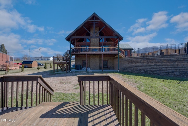 deck with a yard and stairway