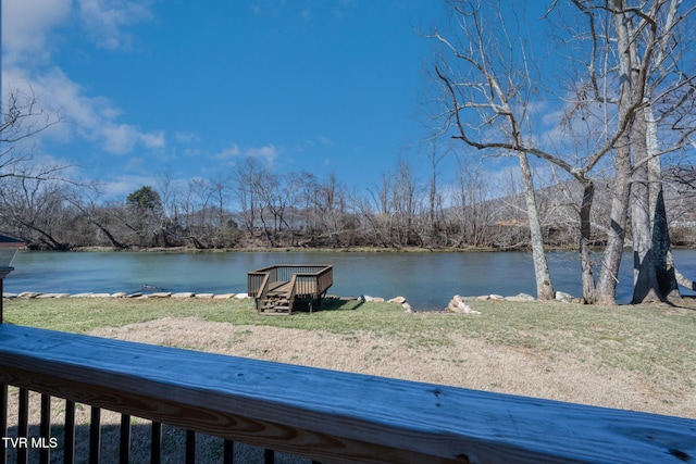 exterior space with a water view and a yard