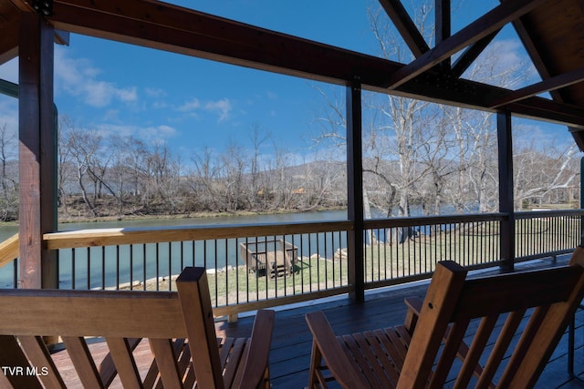 wooden deck featuring a water view