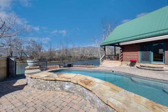 view of pool with a patio area, a jacuzzi, fence, and a fenced in pool