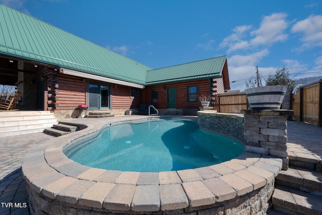 view of swimming pool featuring a patio area and a fenced in pool