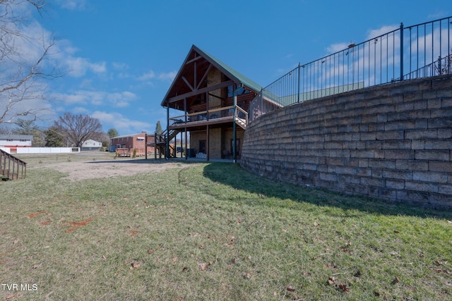 rear view of property with a yard and stairway