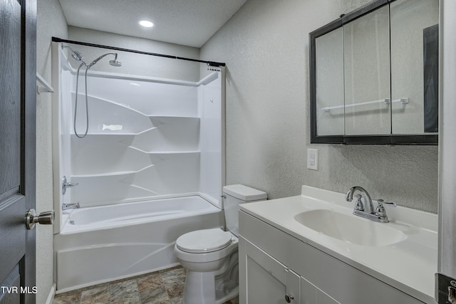 full bath with a textured wall, toilet, washtub / shower combination, a textured ceiling, and vanity