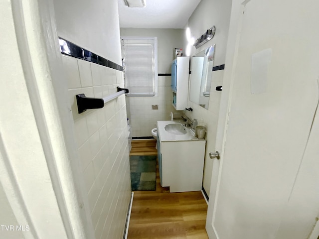 1536 Pineola Ave, Kingsport, TN 37664 - bathroom featuring toilet, vanity, wood finished floors, wainscoting, and tile walls