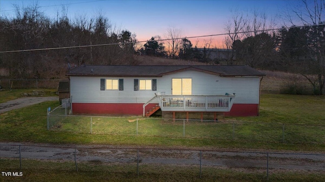 view of front facade featuring stairs, a front yard, and a fenced backyard