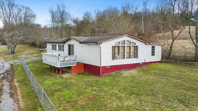 back of property featuring crawl space, a yard, a wooden deck, and fence