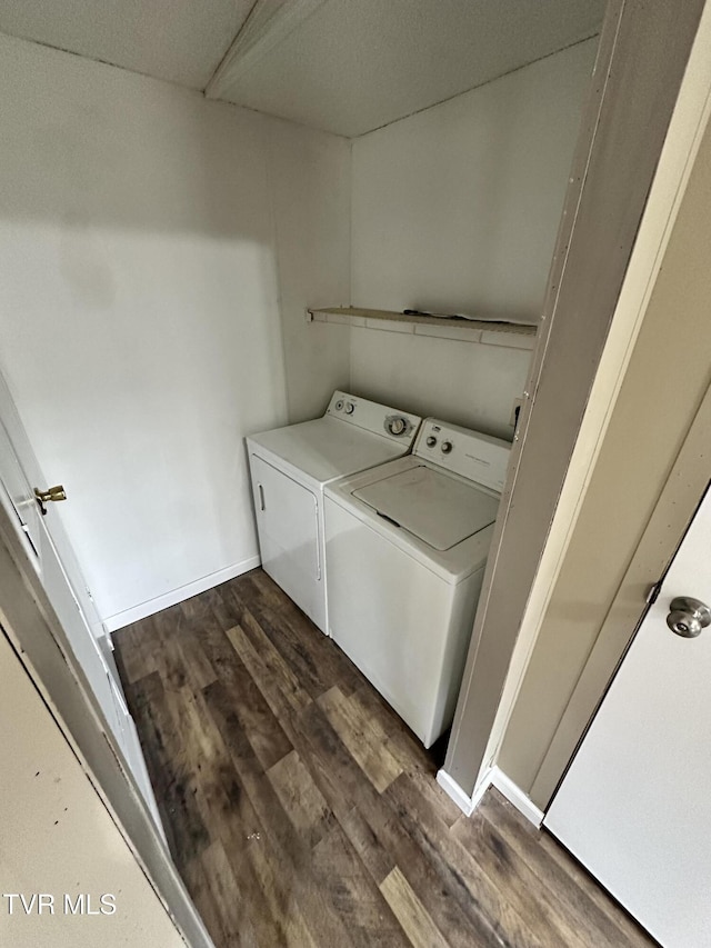 laundry room with washing machine and dryer, dark wood-style flooring, baseboards, and laundry area