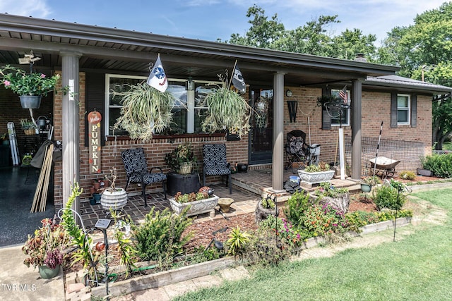 view of front of house featuring a porch and brick siding