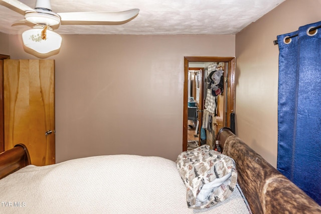 bedroom with a textured ceiling and ceiling fan