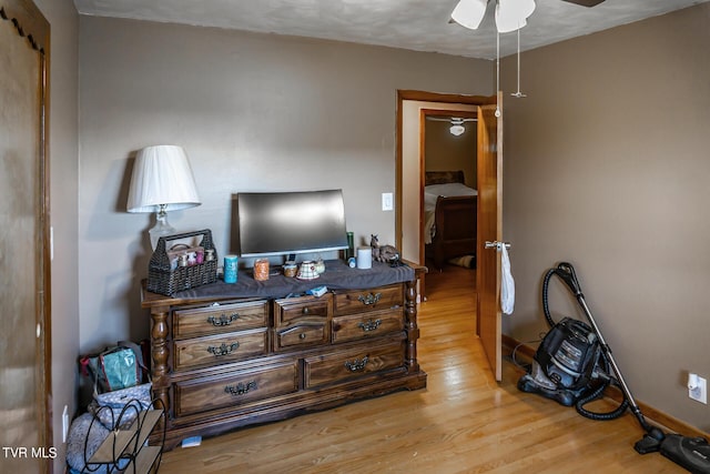 bedroom featuring wood finished floors and baseboards