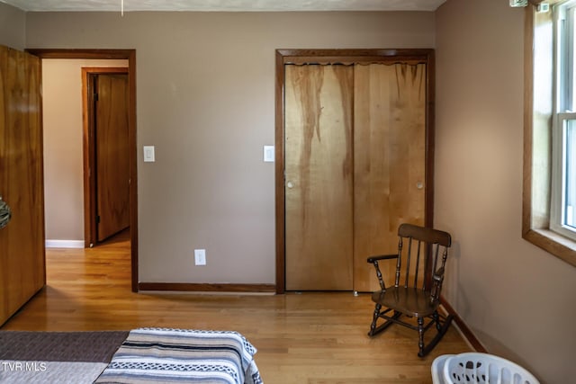 bedroom featuring wood finished floors and baseboards