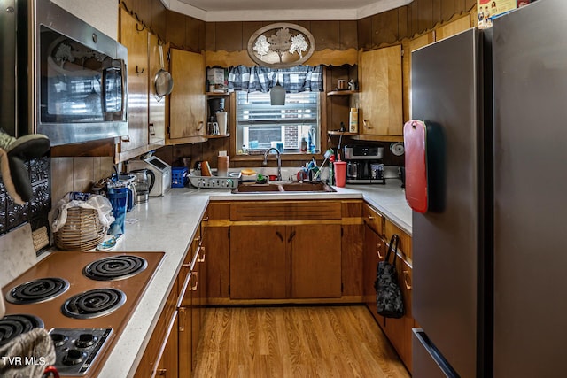 kitchen featuring light countertops, appliances with stainless steel finishes, open shelves, and a sink