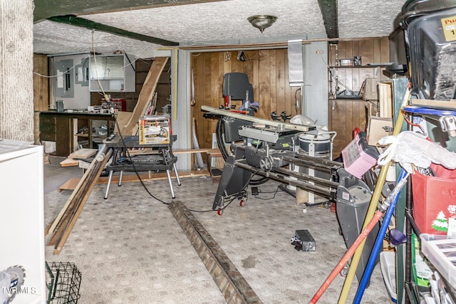 miscellaneous room with wooden walls and a workshop area