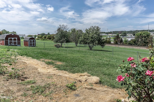 view of yard with fence and an outdoor structure