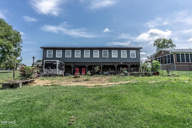 rear view of property featuring a yard