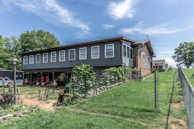 view of side of home with brick siding, fence, and a yard