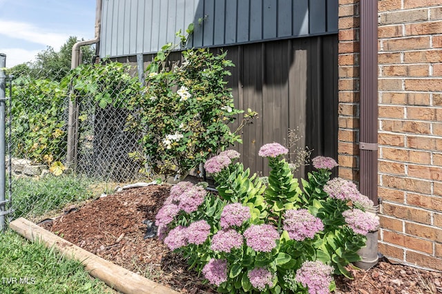 details featuring brick siding and fence