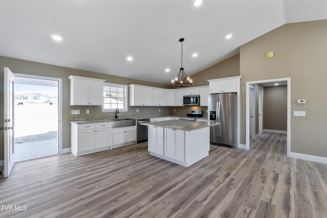 kitchen with white cabinetry, a kitchen island, appliances with stainless steel finishes, and a sink