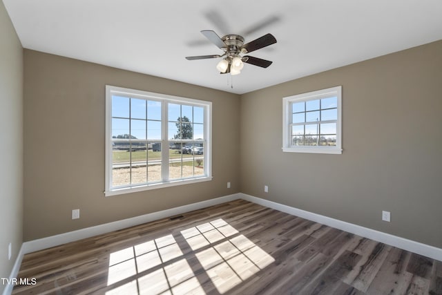 unfurnished room with a healthy amount of sunlight and baseboards