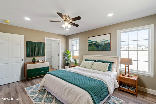 bedroom with a ceiling fan, recessed lighting, light wood-style flooring, and baseboards