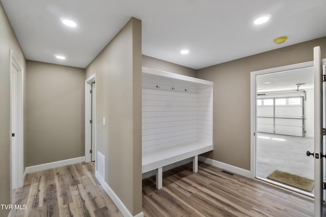 mudroom featuring recessed lighting, light wood-style flooring, and baseboards