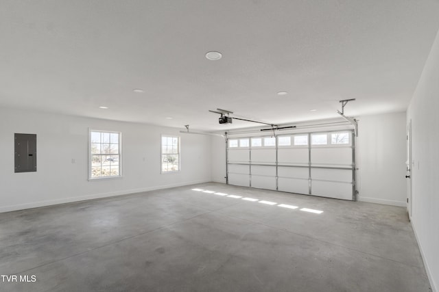 garage featuring baseboards, electric panel, and a garage door opener