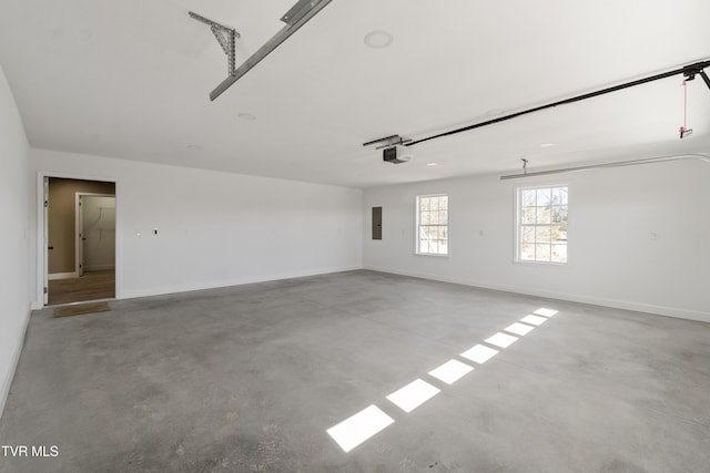 garage with electric panel, baseboards, and a garage door opener