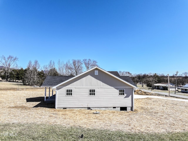 view of side of property with a shingled roof