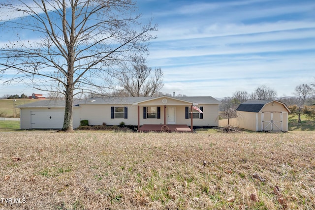 view of front facade featuring a garage, a storage shed, covered porch, and an outdoor structure