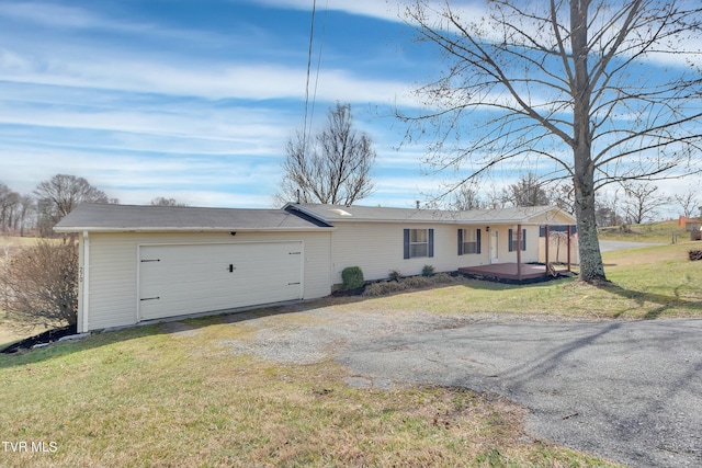 view of front of property with driveway, a front lawn, and an attached garage