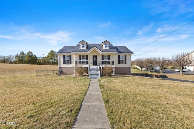 view of front of house with metal roof, a front lawn, and a porch