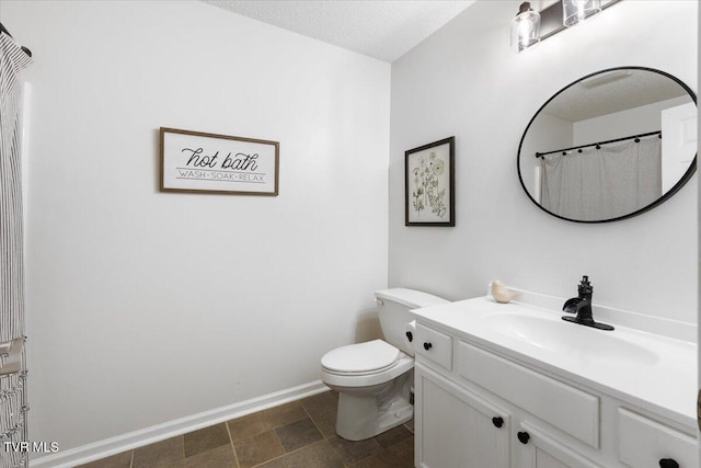 full bathroom with toilet, baseboards, a textured ceiling, and vanity