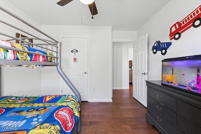 bedroom with ceiling fan, a textured ceiling, and wood finished floors