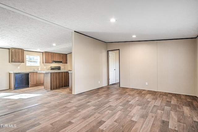 kitchen featuring light wood-style floors, light countertops, dishwasher, and brown cabinetry