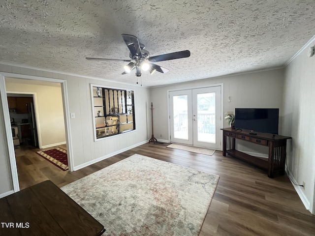 living area featuring a textured ceiling, wood finished floors, crown molding, and french doors