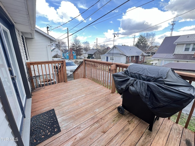 deck with a residential view and grilling area