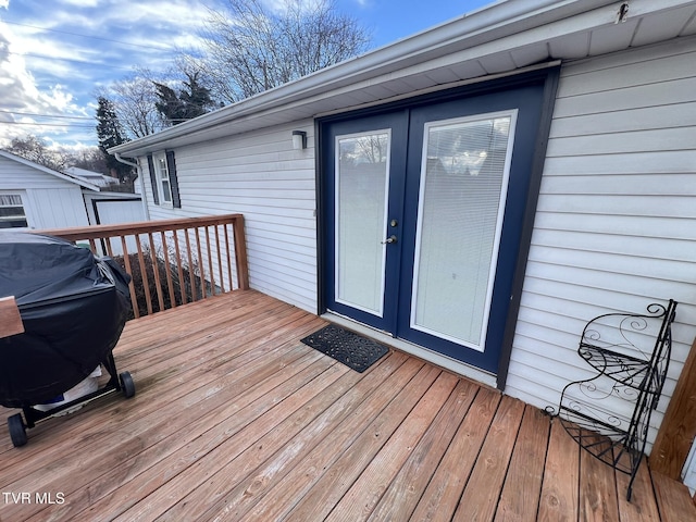 deck with french doors and a grill