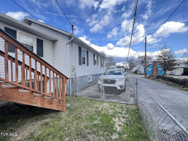 exterior space with a lawn, fence, and a gate