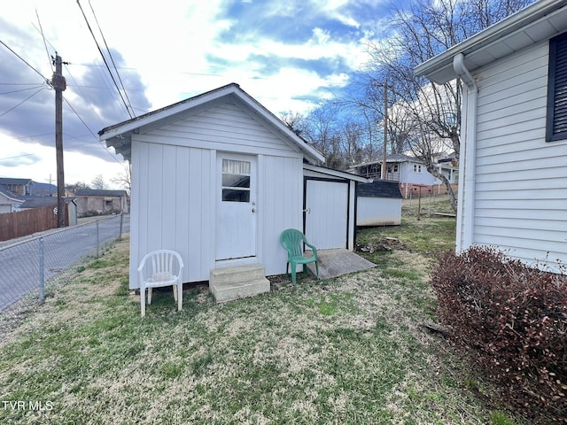 view of shed featuring fence