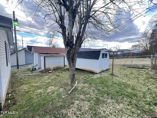 view of yard with a fenced backyard, an outdoor structure, and a storage shed