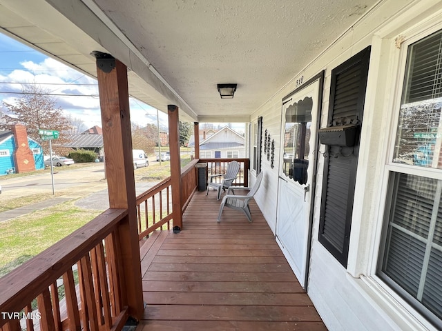 wooden terrace featuring covered porch