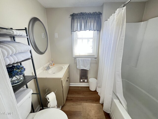 bathroom with vanity, shower / bath combo with shower curtain, wood finished floors, and toilet