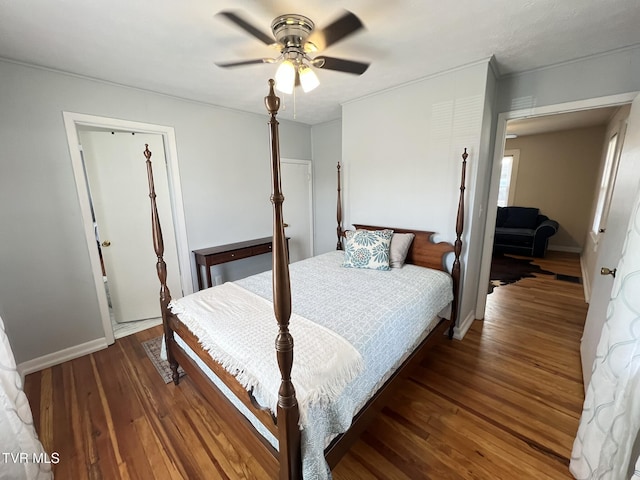 bedroom featuring ceiling fan, wood finished floors, and baseboards