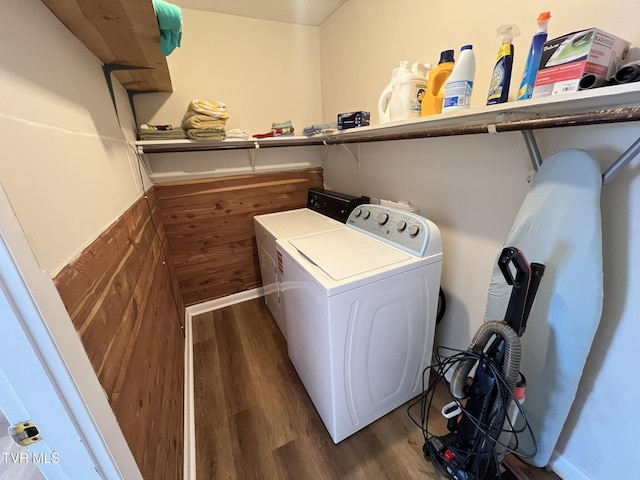 laundry area featuring washing machine and dryer, laundry area, and wood finished floors