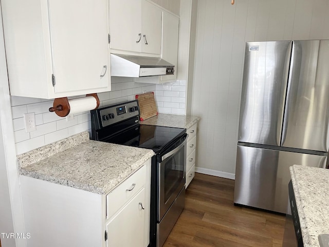 kitchen with under cabinet range hood, stainless steel appliances, wood finished floors, white cabinets, and backsplash