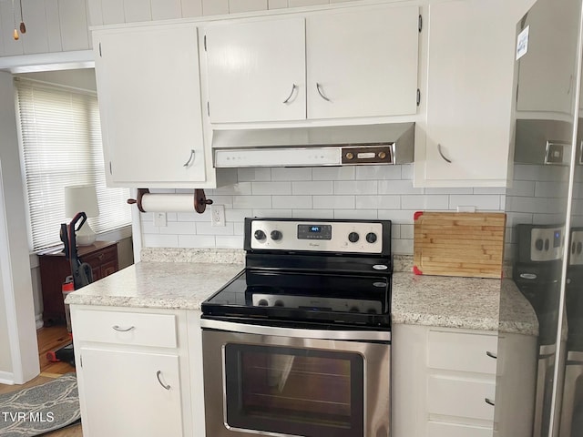 kitchen featuring stainless steel range with electric stovetop, white cabinetry, and wall chimney exhaust hood