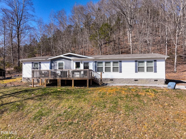 manufactured / mobile home with crawl space, a wooden deck, and a front lawn