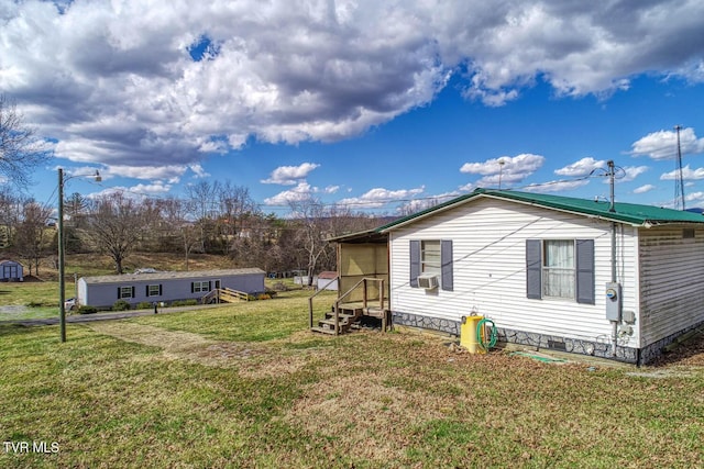 view of side of home with crawl space, cooling unit, and a yard