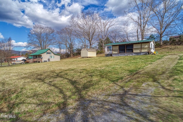 view of yard featuring a storage shed and an outbuilding