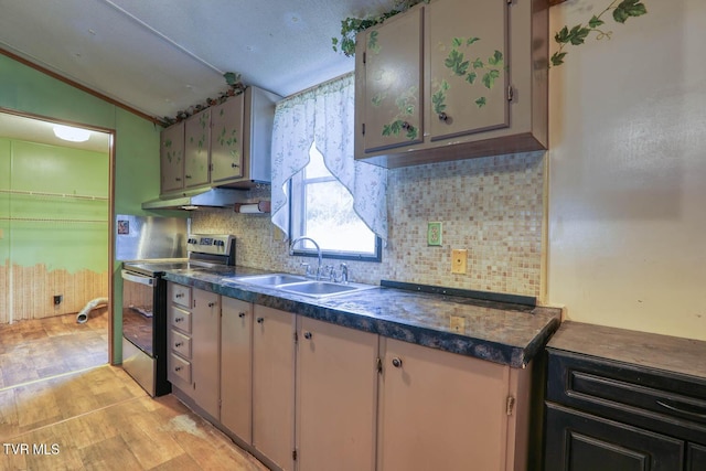 kitchen with under cabinet range hood, a sink, backsplash, stainless steel electric stove, and dark countertops